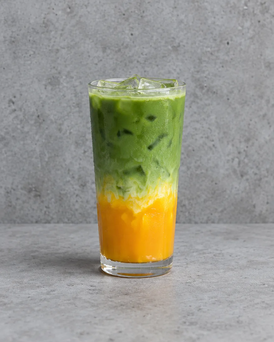 Mango Iced Matcha Latte — Matcha latte layered over mango