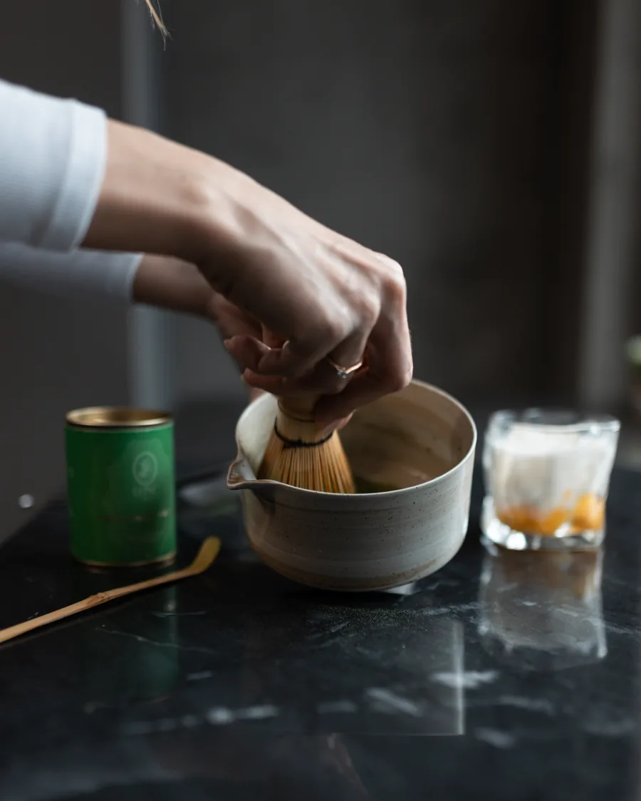 Matcha being whisked in a ceramic bowl