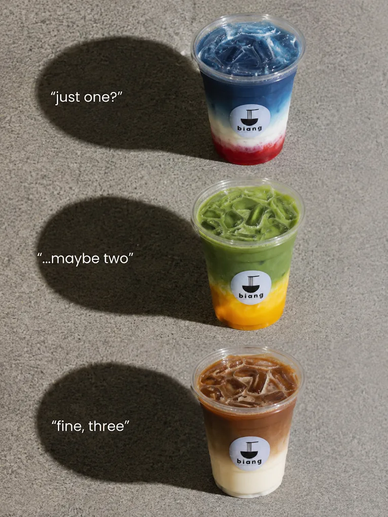Three layered iced drinks in Biang cups: butterfly pea, matcha and iced coffee